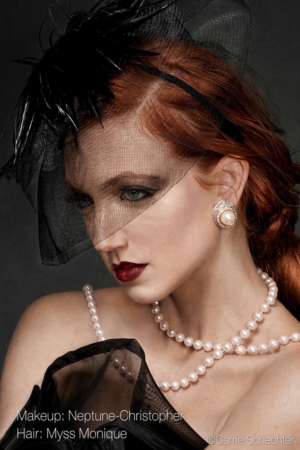 Classic editorial beauty look with smoky eyes and deep red lip beneath a black veil